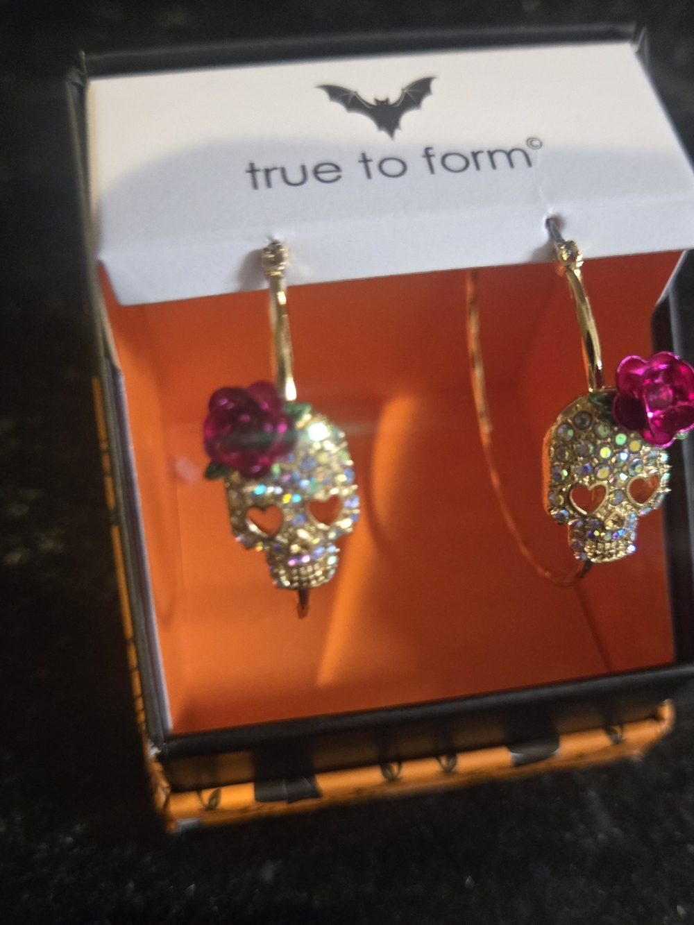 True To Form Gold Skull Hoop Earrings with Pink Flower Accent